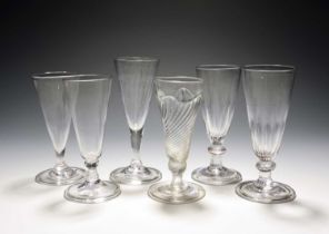 Six dwarf ale glasses or flutes, c.1730-60, one with flammiform moulding, two with vertical