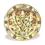 A Kutahya Iznik-style dish, late 18th/19th century, boldly painted with a formal arrangement of