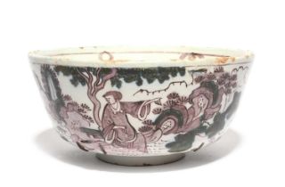 A Delft bowl, c.1690-1710, painted in manganese and green with Chinese figures in a continuous