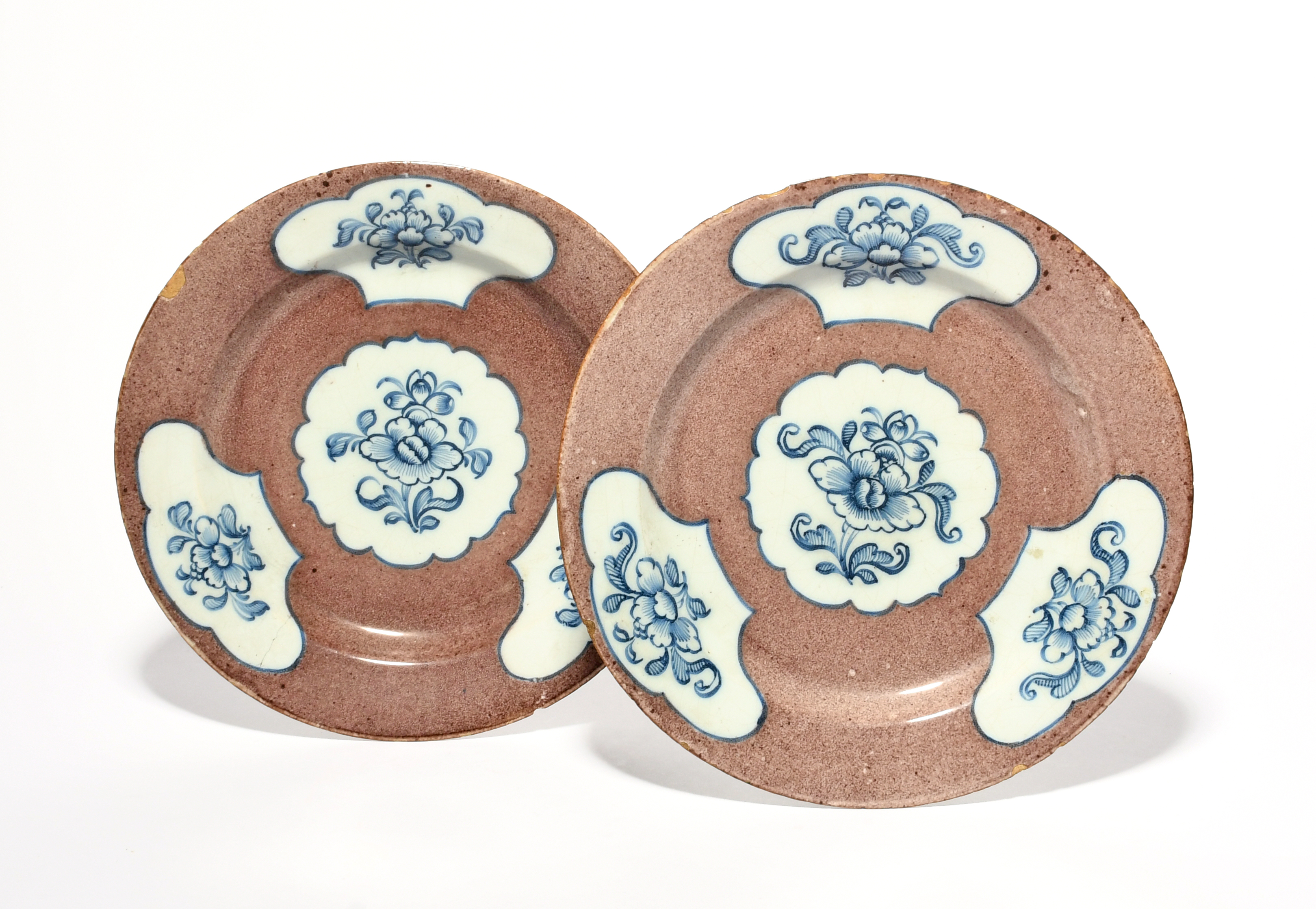 A pair of Wincanton delftware plates, c.1760, painted with three shaped panels of stylised flower - Image 2 of 2