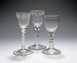 Three wine glasses, c.1760-70, one with a bucket bowl engraved with grapevine and raised on an