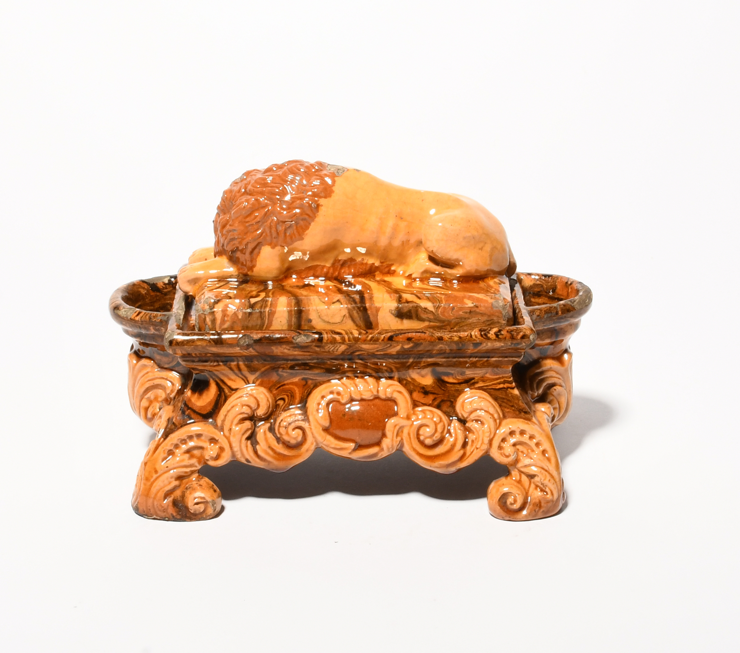 A slipware double inkwell, 19th century, the cover modelled with a recumbent lion, the rectangular - Image 2 of 4