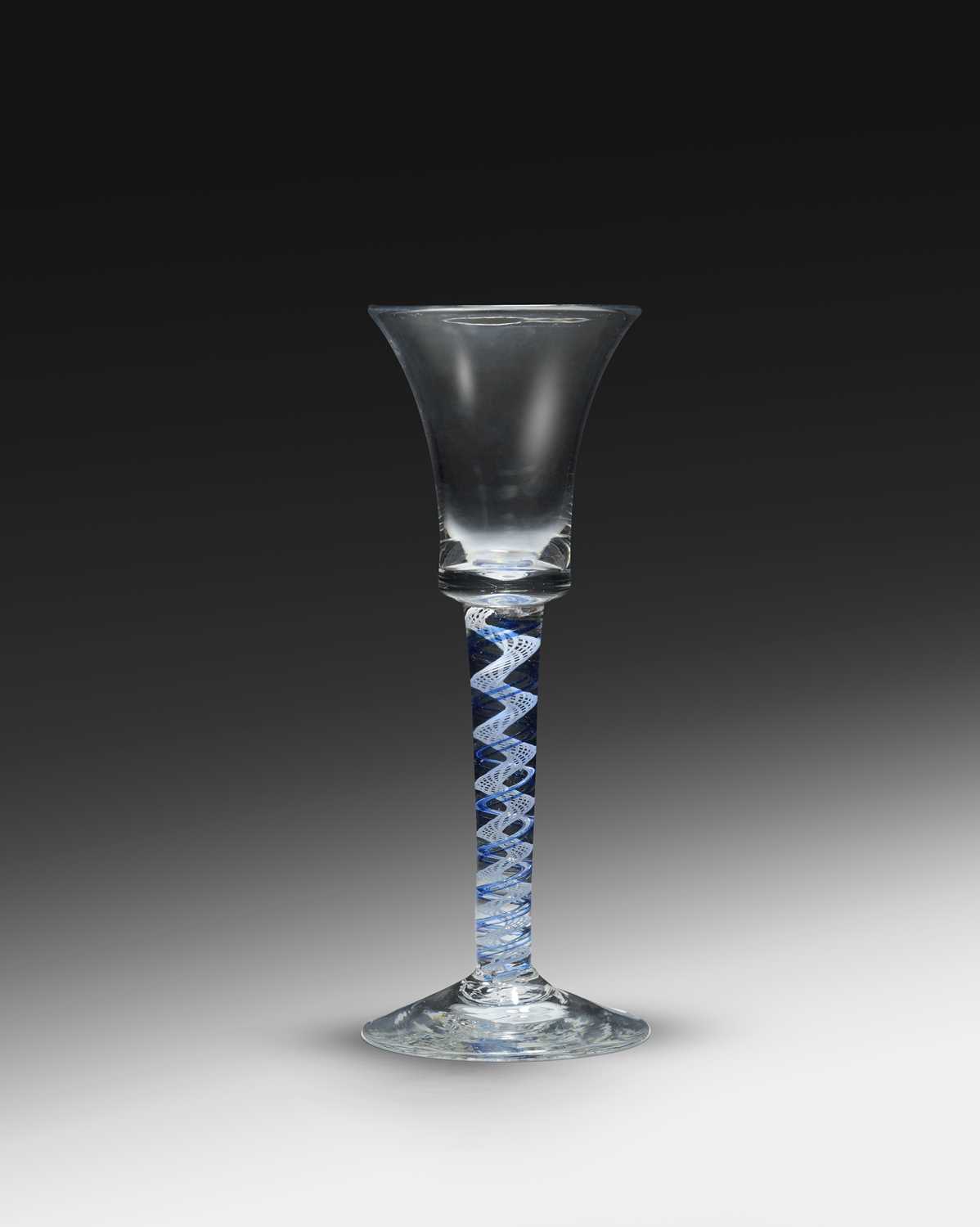 A colour twist wine glass, c.1760-70, the bell bowl raised on a stem combining blue spirals around a