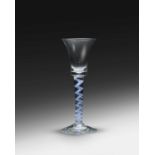 A colour twist wine glass, c.1760-70, the bell bowl raised on a stem combining blue spirals around a