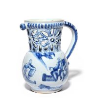 An unusual Delft puzzle jug, 18th century, the globular body painted in blue with a figure holding