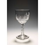 An unusual glass goblet, c.1770, the cup bowl engraved with a scene of a figure carrying ladders