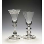 Two baluster wine glasses, c.1730, one with a bell bowl engraved with a stylised foliate band,