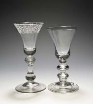 Two baluster wine glasses, c.1730, one with a bell bowl engraved with a stylised foliate band,