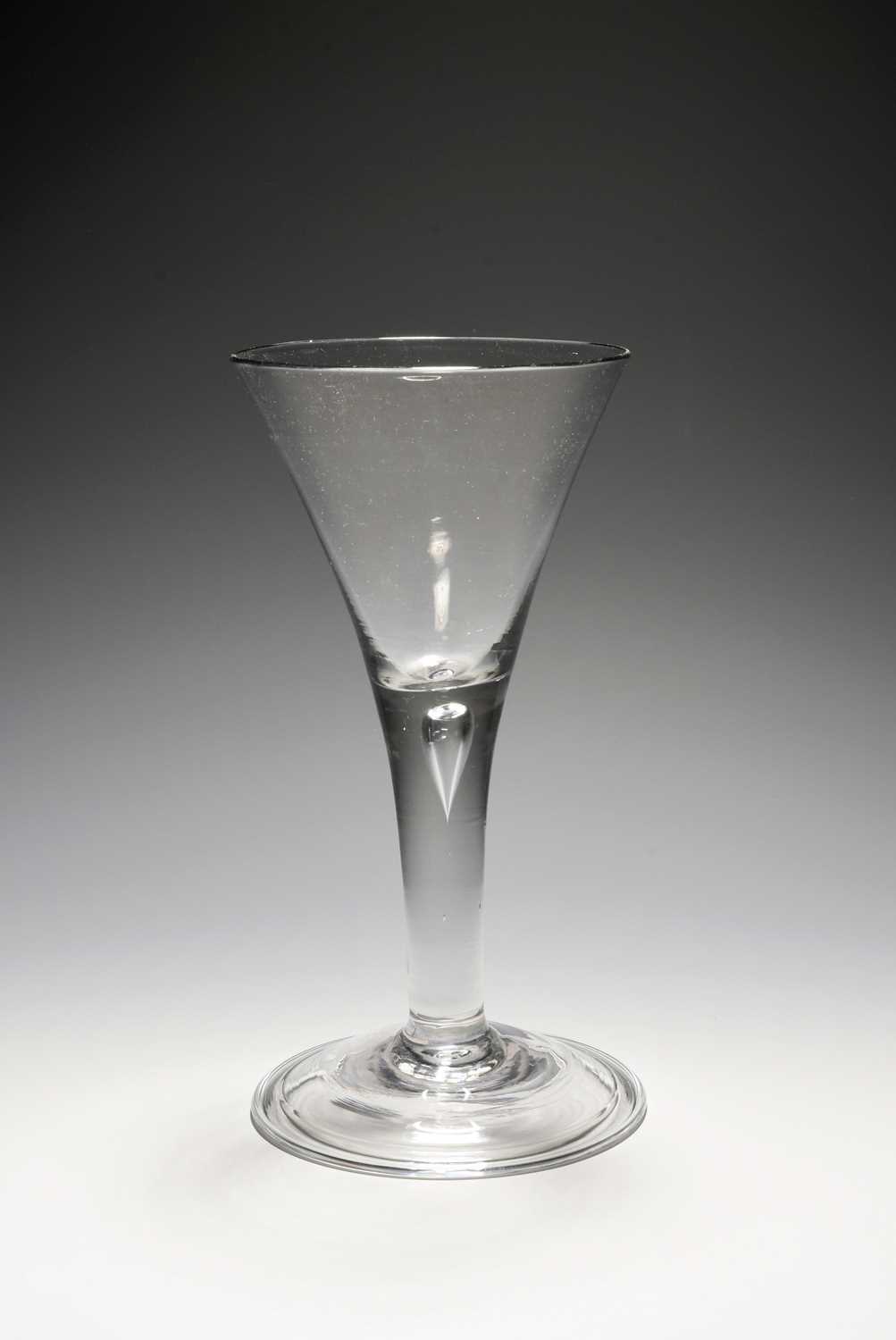 A large wine glass or goblet, c.1740, the generous drawn trumpet bowl raised on a plain stem