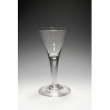 A large wine glass or goblet, c.1740, the generous drawn trumpet bowl raised on a plain stem