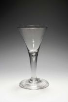 A large wine glass or goblet, c.1740, the generous drawn trumpet bowl raised on a plain stem