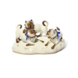 A Meissen group of pugs at play, 19th century, the three dogs wearing blue ribbon collars with