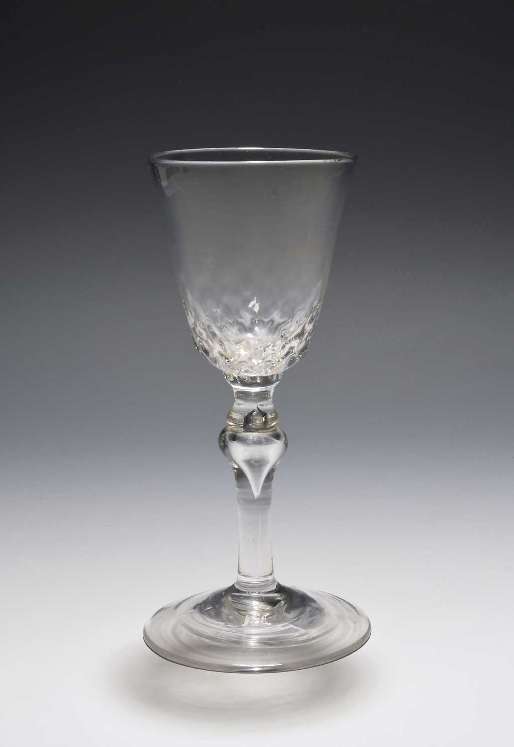 A balustroid wine glass, c.1730-40, the generous round funnel bowl with honeycomb moulding to the