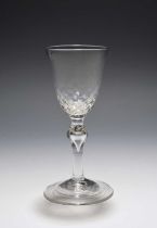 A balustroid wine glass, c.1730-40, the generous round funnel bowl with honeycomb moulding to the