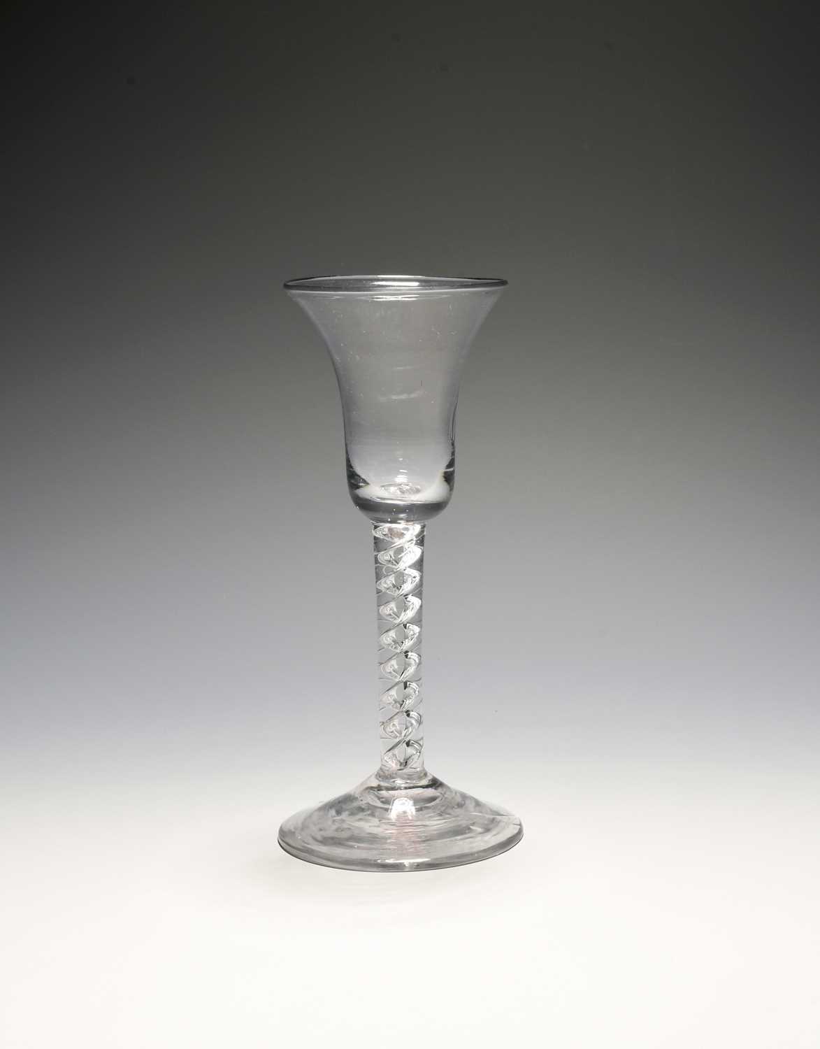 A wine glass, c.1740-50, with a bell bowl raised on a mercury twist stem over a conical foot, 15.