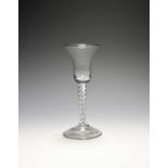 A wine glass, c.1740-50, with a bell bowl raised on a mercury twist stem over a conical foot, 15.