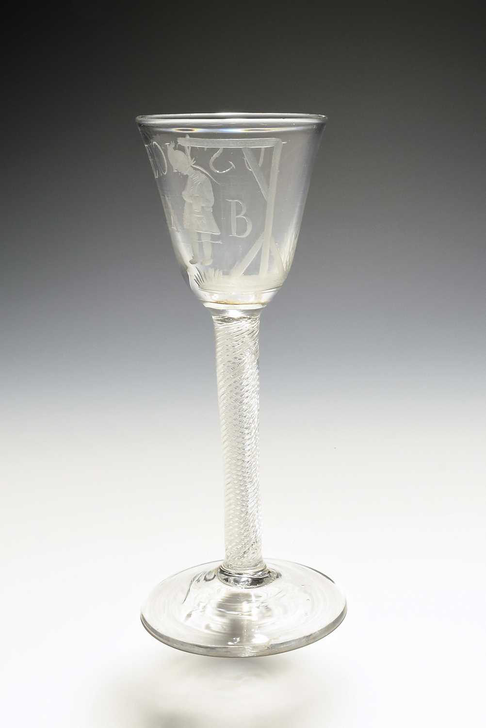 An Admiral Byng wine glass, c.1763, the round funnel bowl engraved with the officer hanging from a - Image 2 of 3