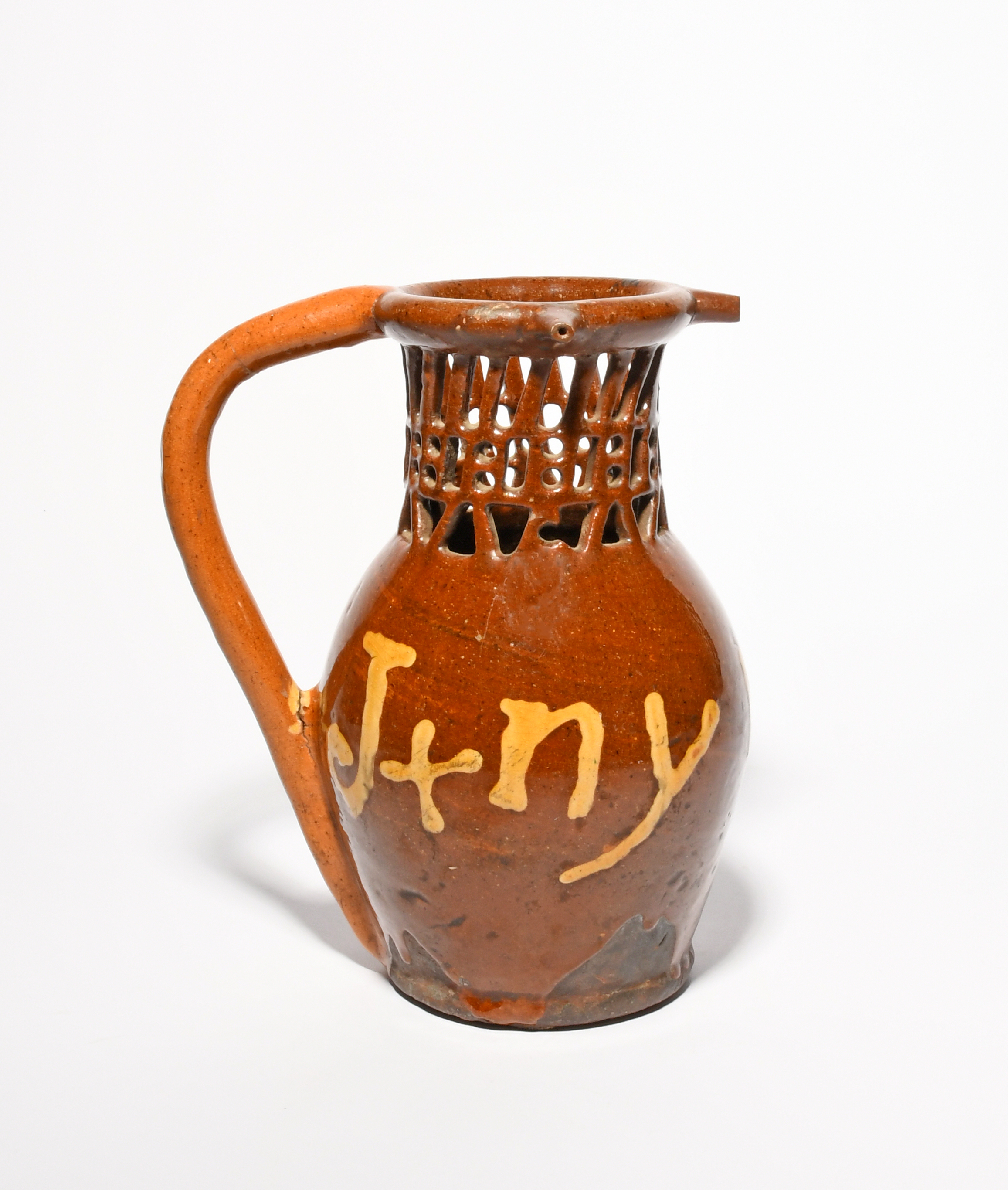 A large slipware puzzle jug, dated 1831, inscribed 'J + ny 1831' in cream slip on a rich treacle - Image 3 of 3