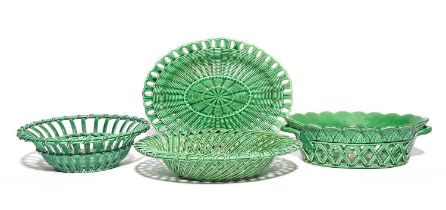 Three Staffordshire green glazed baskets and a stand, c.1760, two oval, one circular, variously