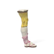 A silver-mounted Mennecy etui or bodkin case, c.1750, modelled as the leg of a gentleman, wearing