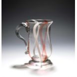 An unusual English glass mug, late 18th century, of bell shape, enclosing colour twists of red and