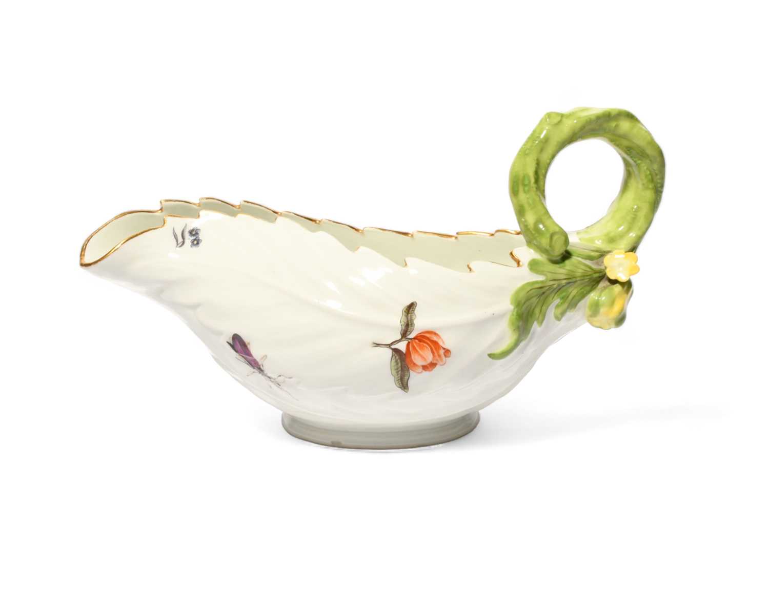 A Meissen leaf-moulded sauceboat, c.1740, formed of overlapping cos leaves, painted with Holzschnitt