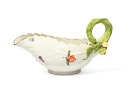 A Meissen leaf-moulded sauceboat, c.1740, formed of overlapping cos leaves, painted with Holzschnitt