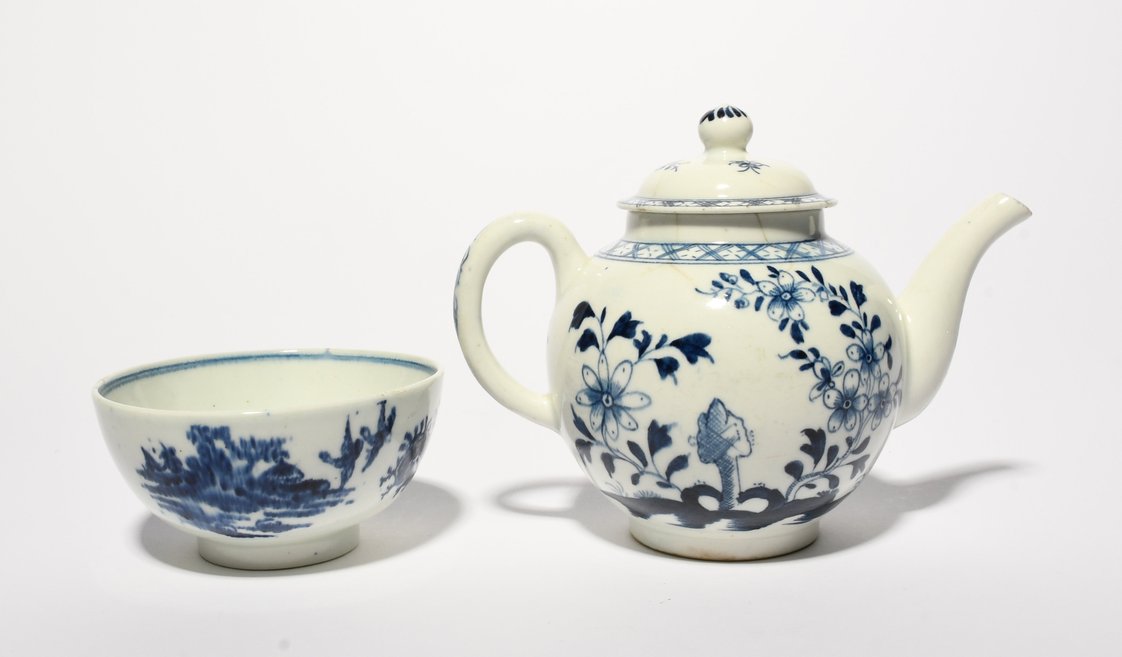 A Lowestoft blue and white teapot and cover, c. 1765-70, painted with flowers emerging from holey - Image 2 of 3