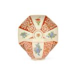 A large Chelsea octagonal teabowl and saucer, c.1750-52, painted with panels of flower stems and