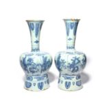 A pair of large Delft vases, c.1700, of Chinese shape, the baluster bodies painted with panels of