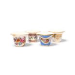 Four Paris porcelain rouge pots, c.1800-30, variously decorated with flowers, one in garland