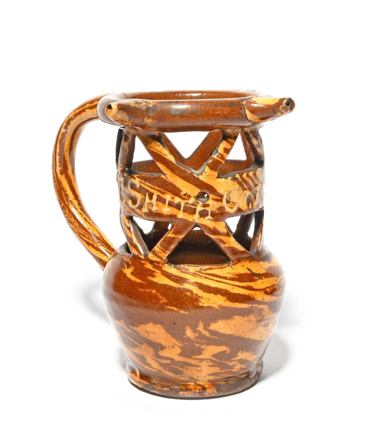 A slipware puzzle jug of agateware type, dated 1901, decorated in cream and treacle slip to simulate