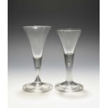 Two wine glasses, c.1740-50, with drawn trumpet bowls rising from plain teared stems over folded