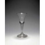 A large wine glass, c.1730, the bell bowl with a solid base enclosing a long tear extending into the