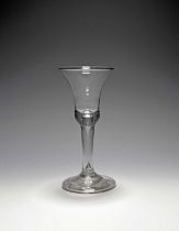 A large wine glass, c.1730, the bell bowl with a solid base enclosing a long tear extending into the