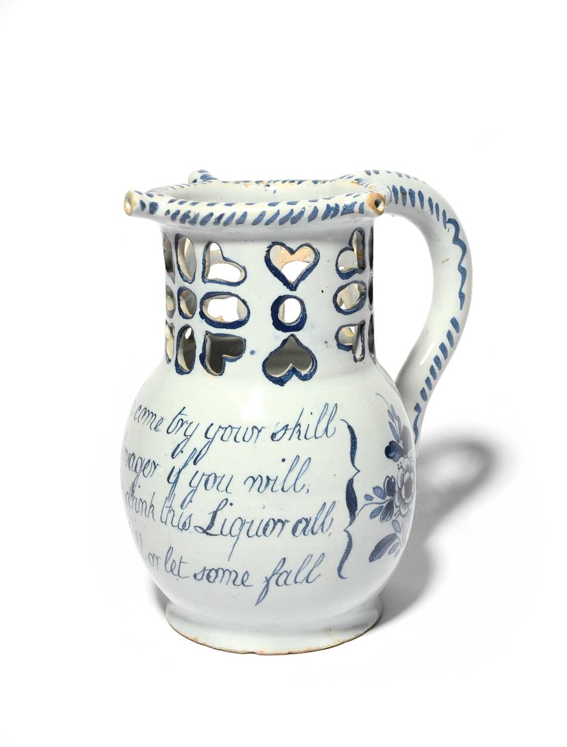A delftware puzzle jug, c.1760, probably Liverpool, painted with flower sprays flanking a four