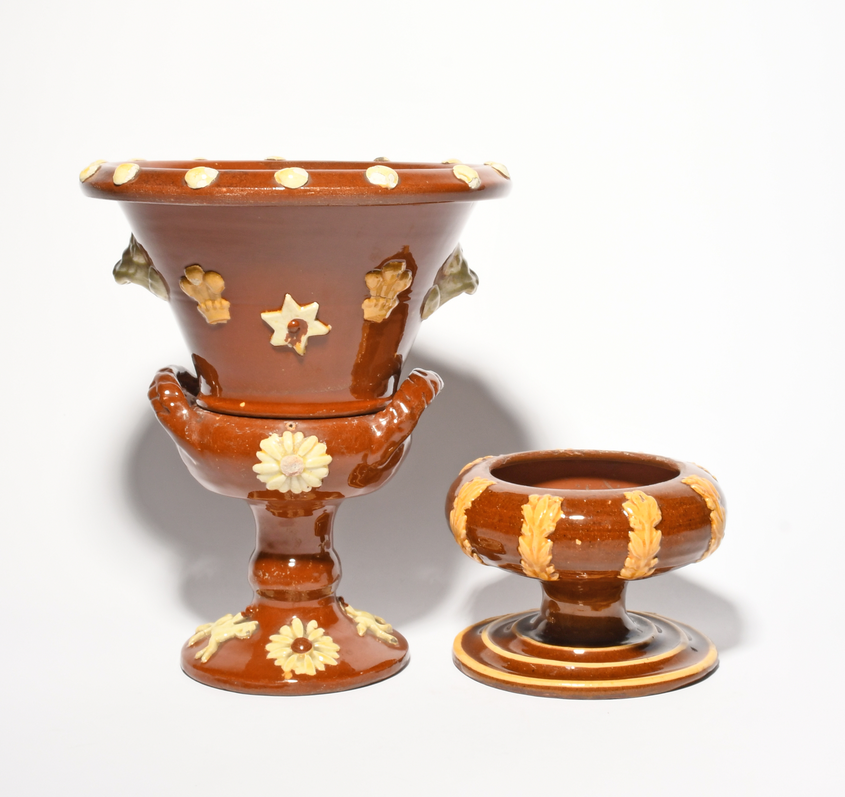 A Yorkshire slipware plant pot and stand, 19th century, the flared top applied with Prince of - Image 2 of 2