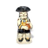 An Ordinary Toby jug and stopper, c.1800, seated with a foaming jug of ale and a long-stemmed