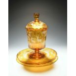 A large Bohemian glass punch pot with cover and stand, mid 19th century, flashed in amber and cut