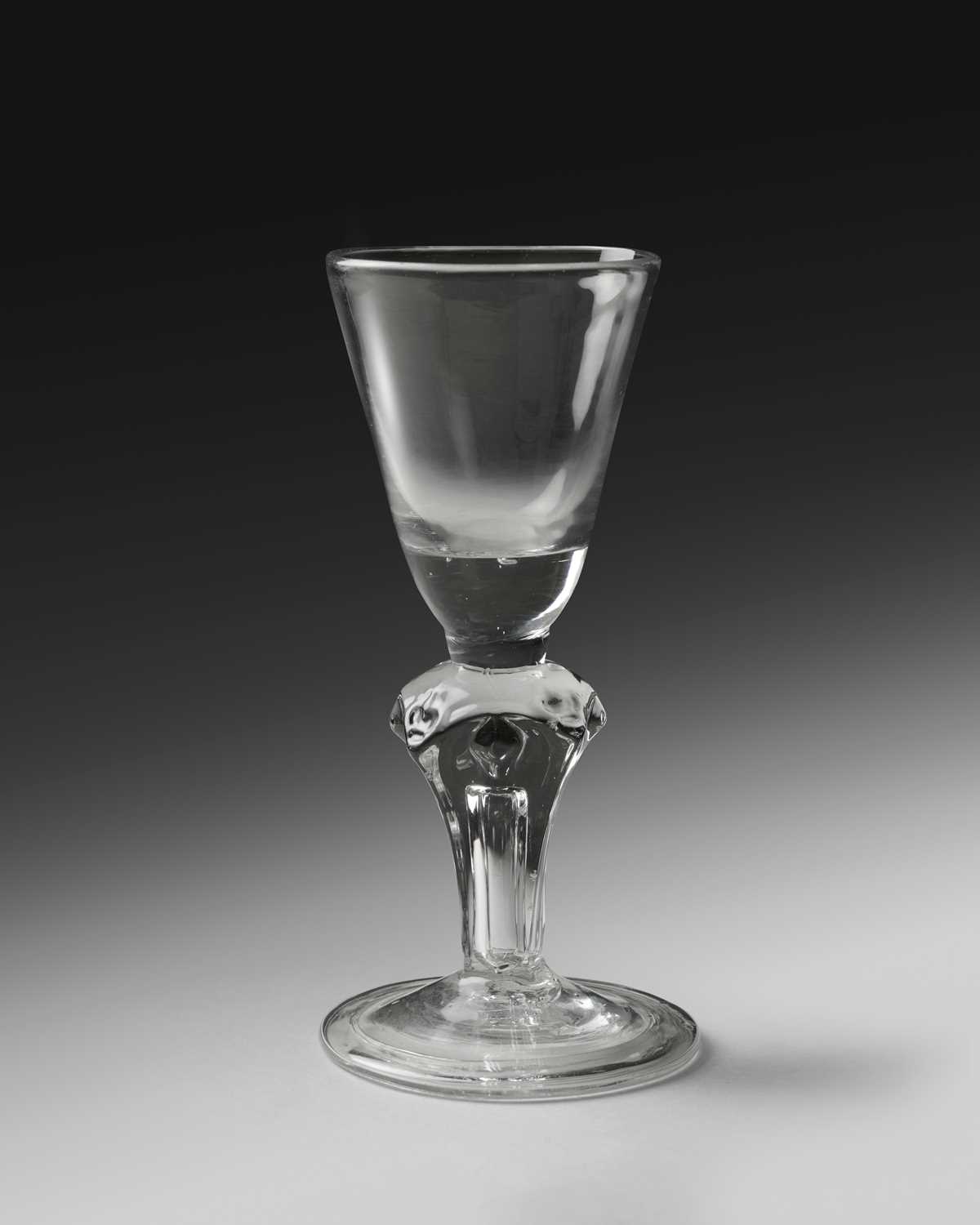 A rare Royal commemorative moulded stem glass, c.1714, the round funnel bowl with a solid base,