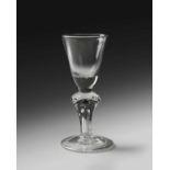 A rare Royal commemorative moulded stem glass, c.1714, the round funnel bowl with a solid base,