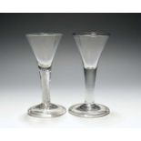 Two wine glasses, c.1740-50, with drawn trumpet bowls, one over a dense airtwist stem, the other