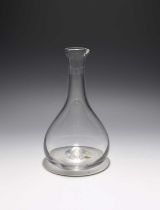 A lipped glass carafe, c.1780, the pear-shaped body rising to a slender neck with short spout,