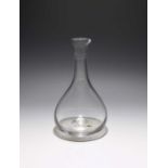 A lipped glass carafe, c.1780, the pear-shaped body rising to a slender neck with short spout,