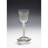 A Jacobite wine glass, c.1760, the generous bucket bowl engraved with a rose and bud spray, the