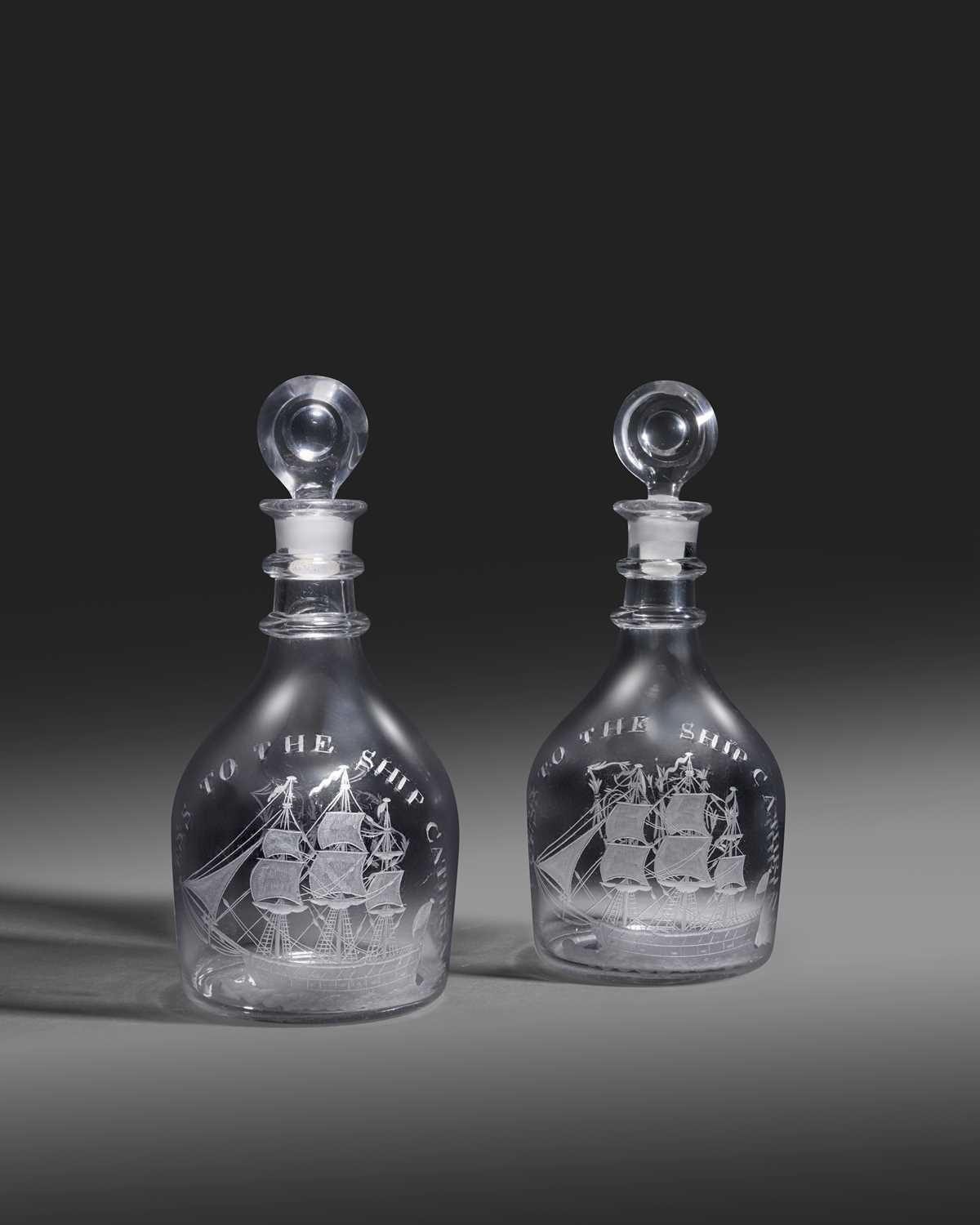 A pair of decanters and stoppers of shipping interest, late 18th/early 19th century, each engraved