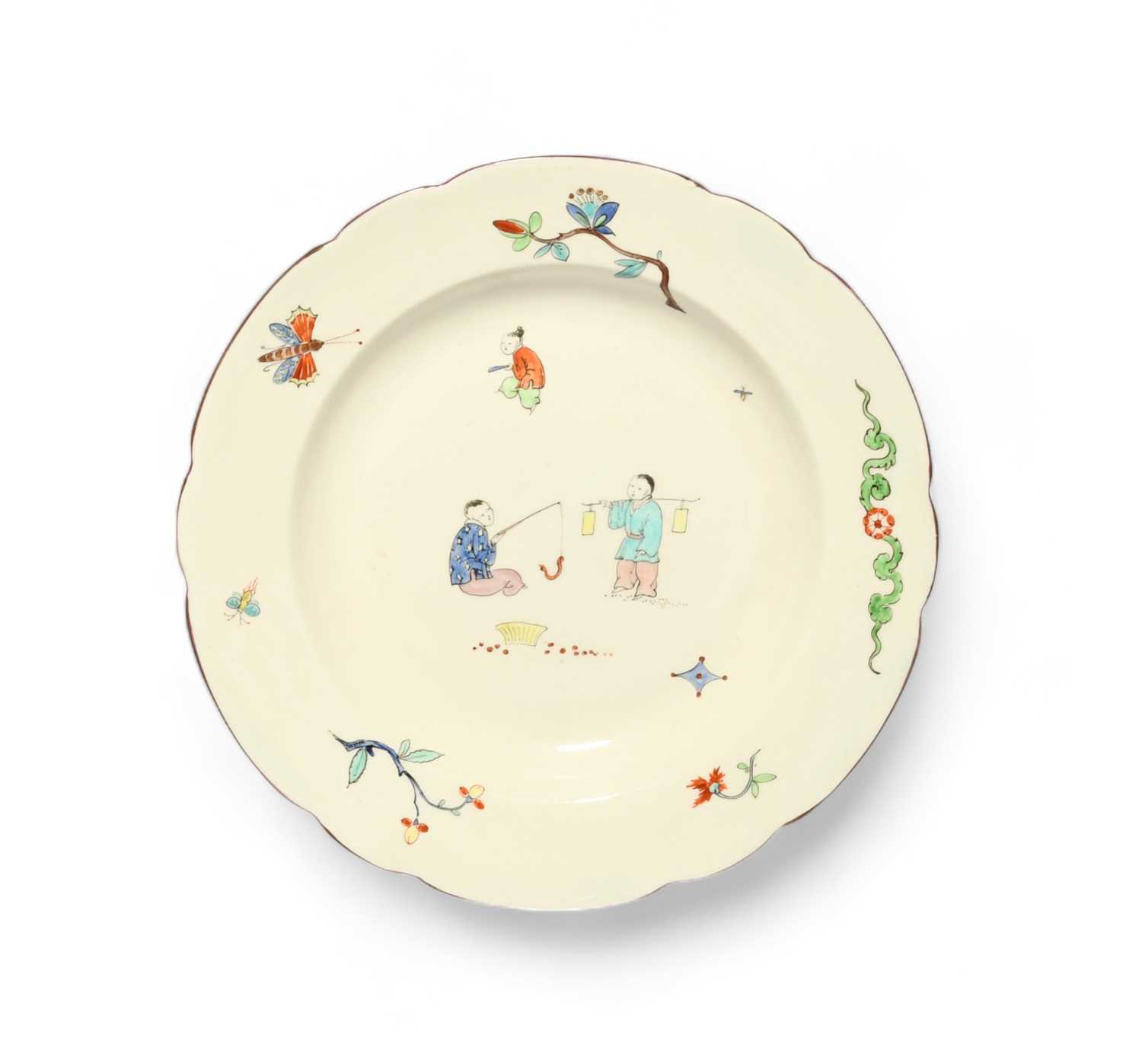 A Chantilly style plate, 19th century, painted in Kakiemon enamels with Chinese boys fishing and