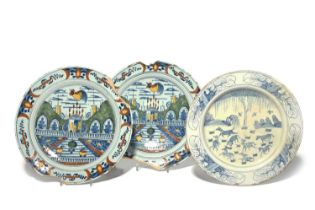A rare pair of Delft plates, early 18th century, boldly painted in blue, red, green and yellow