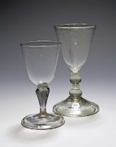 Two unusual Continental lead wine glasses, 18th century, with rounded funnel bowls, one of