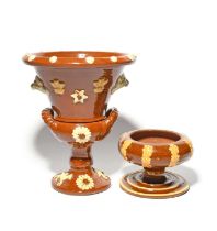 A Yorkshire slipware plant pot and stand, 19th century, the flared top applied with Prince of